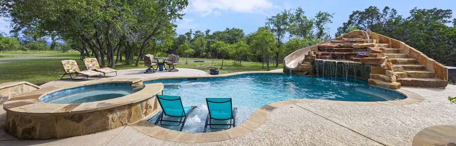 Outdoor pool and waterfall feature at a Texas vacation rental