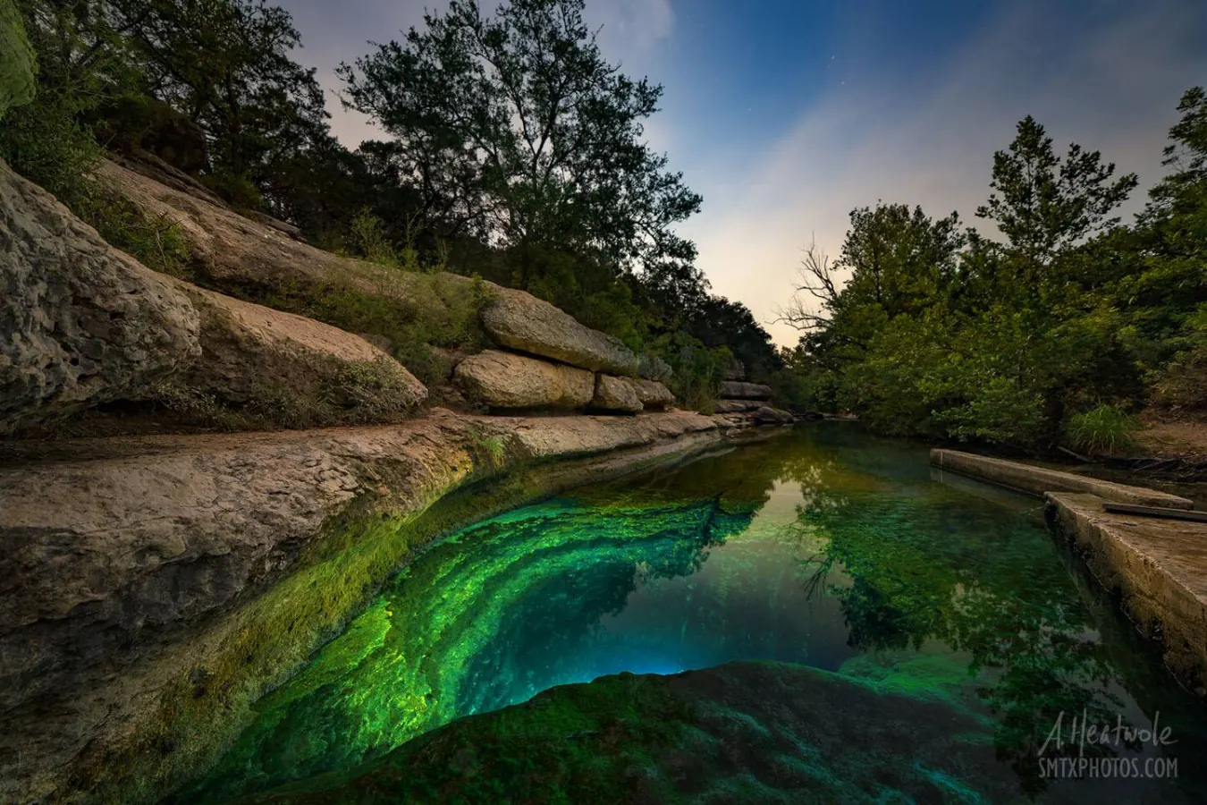 A limestone swimming hole surrounded by Hill Country trees